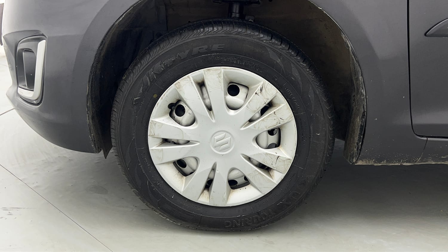 Used 2017 Maruti Suzuki Swift Lxi (O) Petrol Manual tyres LEFT FRONT TYRE RIM VIEW