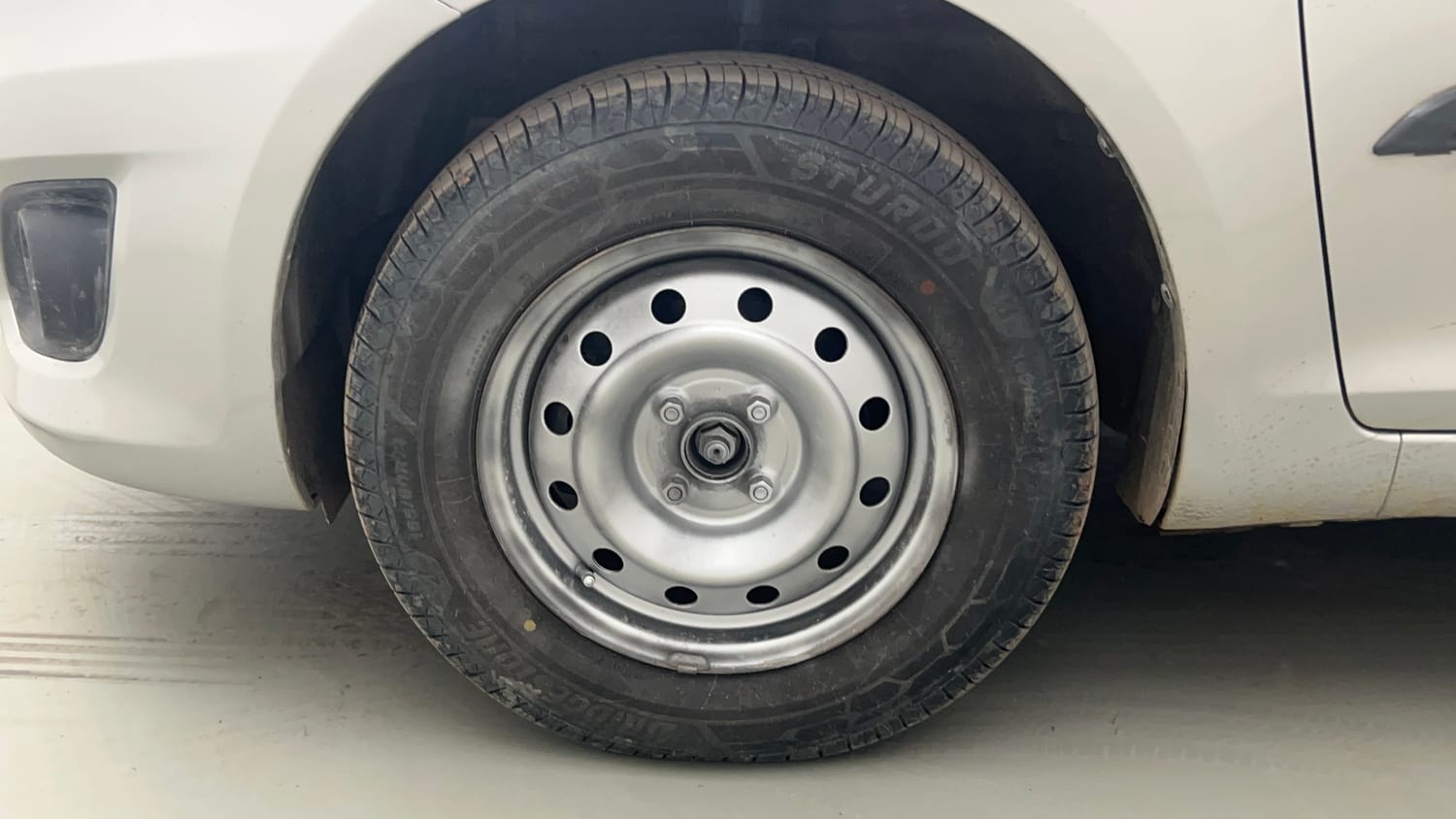 Used 2014 Maruti Suzuki Swift Dzire VXI Petrol Manual tyres LEFT FRONT TYRE RIM VIEW