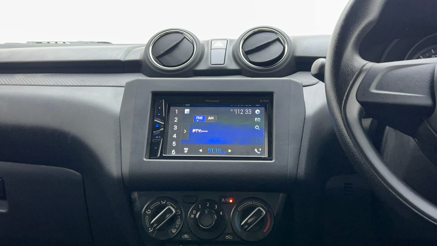 Used 2023 Maruti Suzuki Swift LXi Petrol Manual interior MUSIC SYSTEM & AC CONTROL VIEW