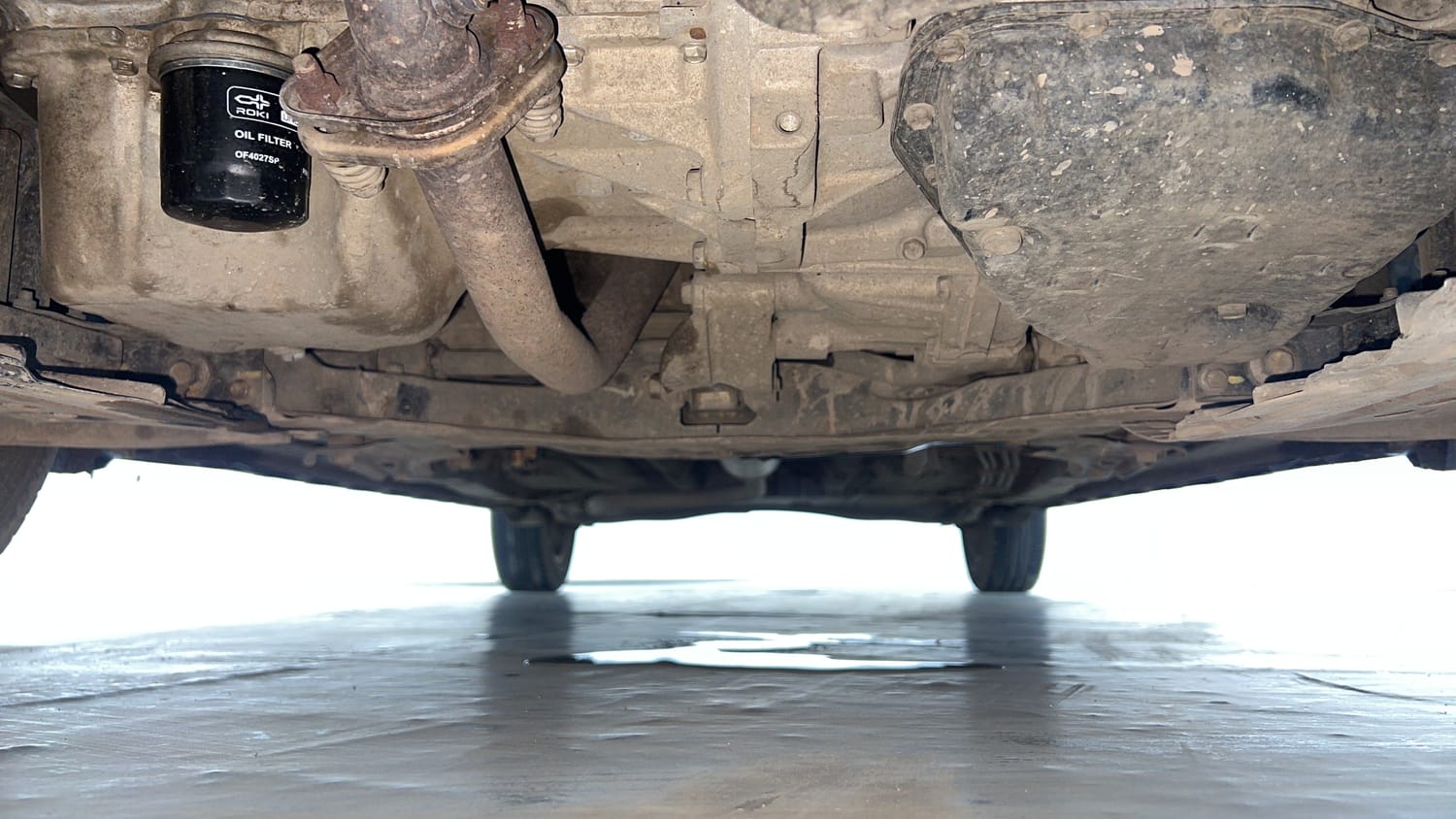 Used 2022 Maruti Suzuki XL6 Zeta AT Petrol Petrol Automatic extra FRONT LEFT UNDERBODY VIEW