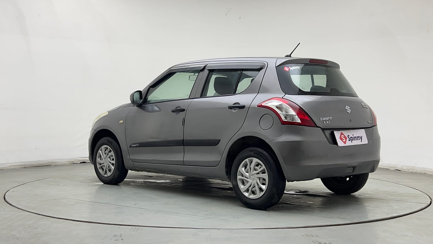 Used 2016 Maruti Suzuki Swift Lxi (O) Petrol Manual exterior LEFT REAR CORNER VIEW