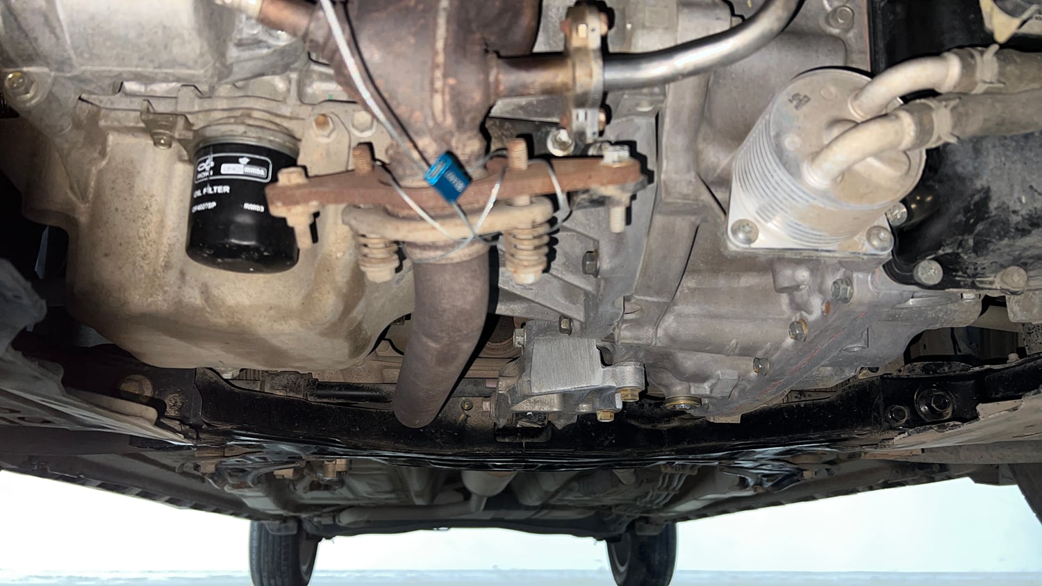Used 2023 Maruti Suzuki XL6 Zeta AT Petrol Petrol Automatic extra FRONT LEFT UNDERBODY VIEW