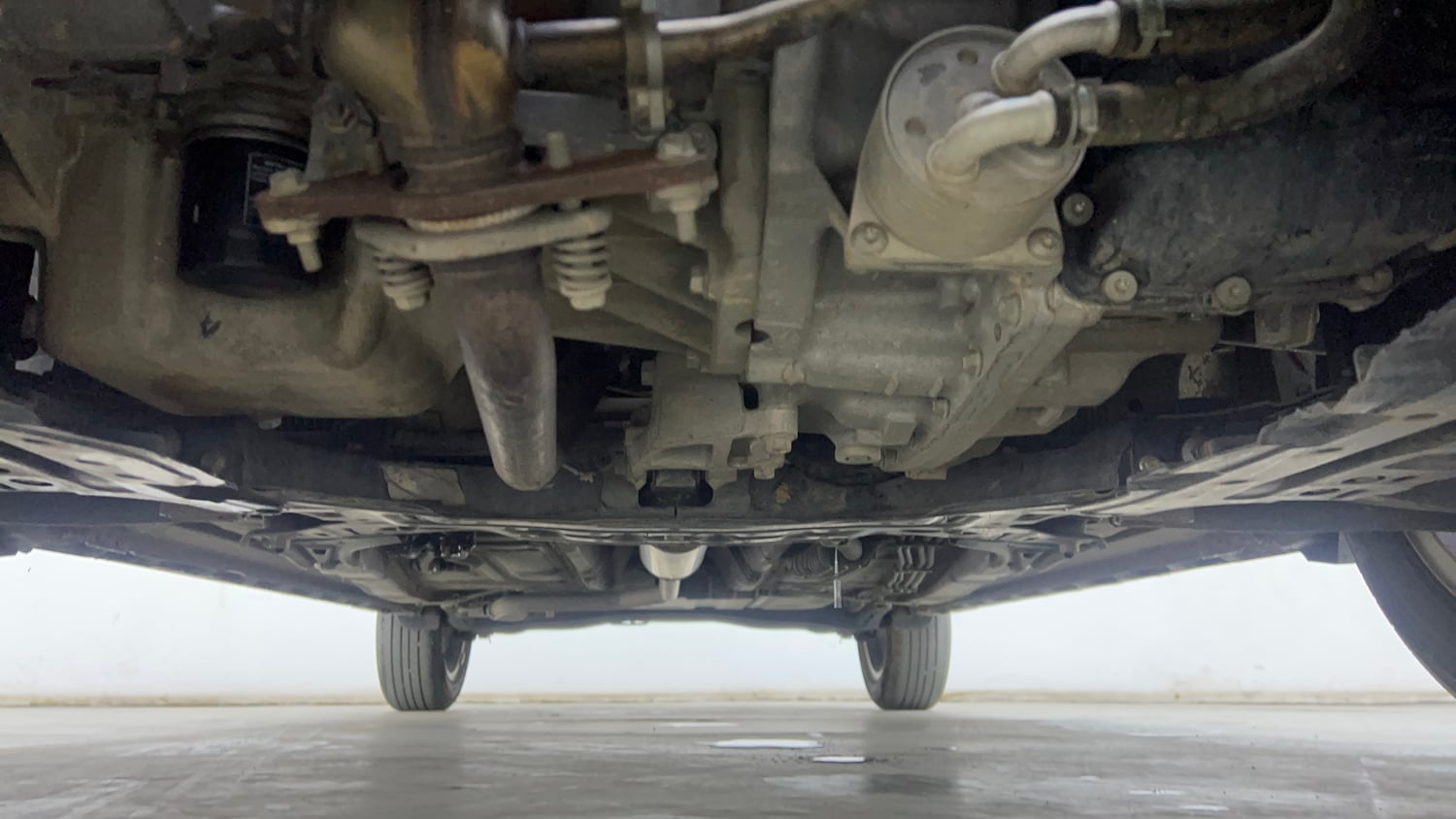 Used 2023 Maruti Suzuki XL6 Zeta AT Petrol Petrol Automatic extra FRONT LEFT UNDERBODY VIEW