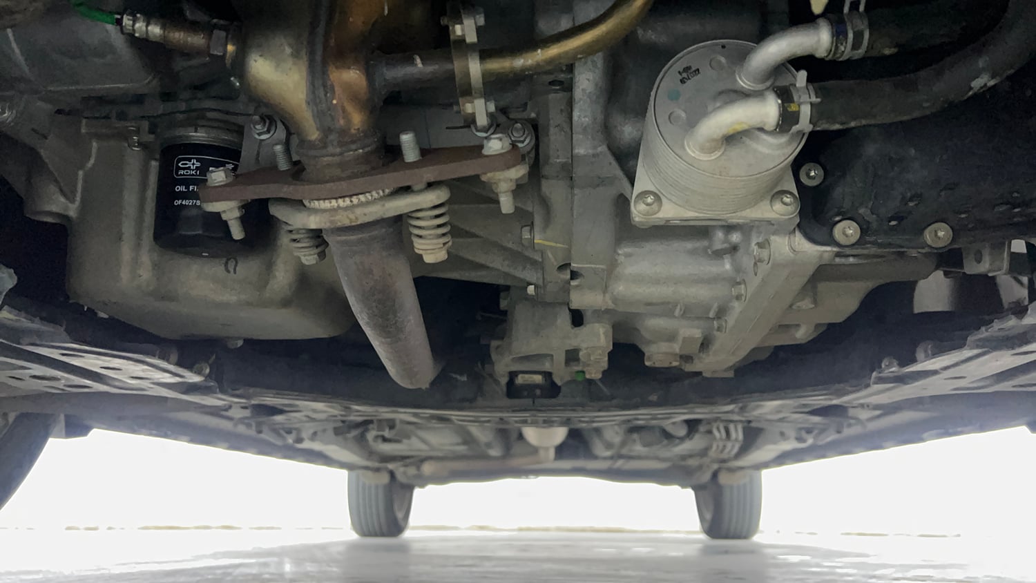 Used 2023 Maruti Suzuki XL6 Alpha AT Petrol Petrol Automatic extra FRONT LEFT UNDERBODY VIEW