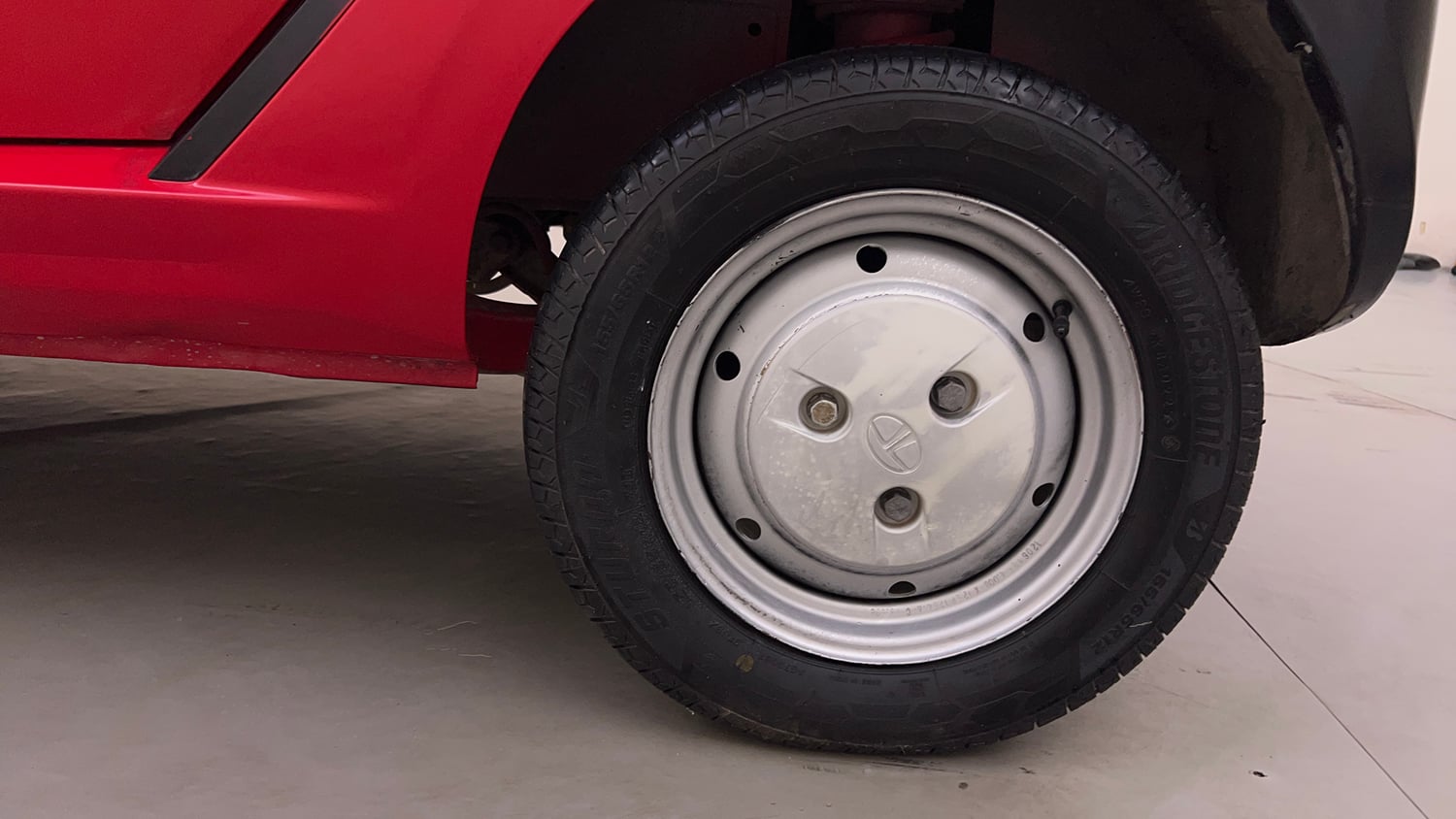Used 2013 Tata Nano CX Petrol Manual tyres LEFT REAR TYRE RIM VIEW