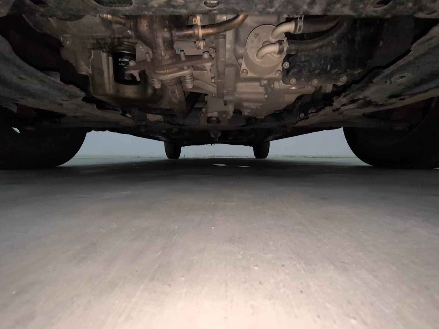 Used 2023 Maruti Suzuki Ertiga VXi AT Petrol Automatic extra FRONT LEFT UNDERBODY VIEW